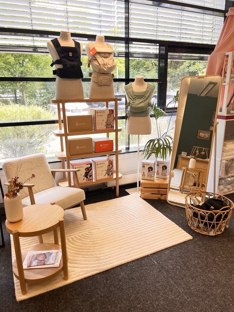 Ergobaby shop-in-shop with baby carriers, armchair and mirror