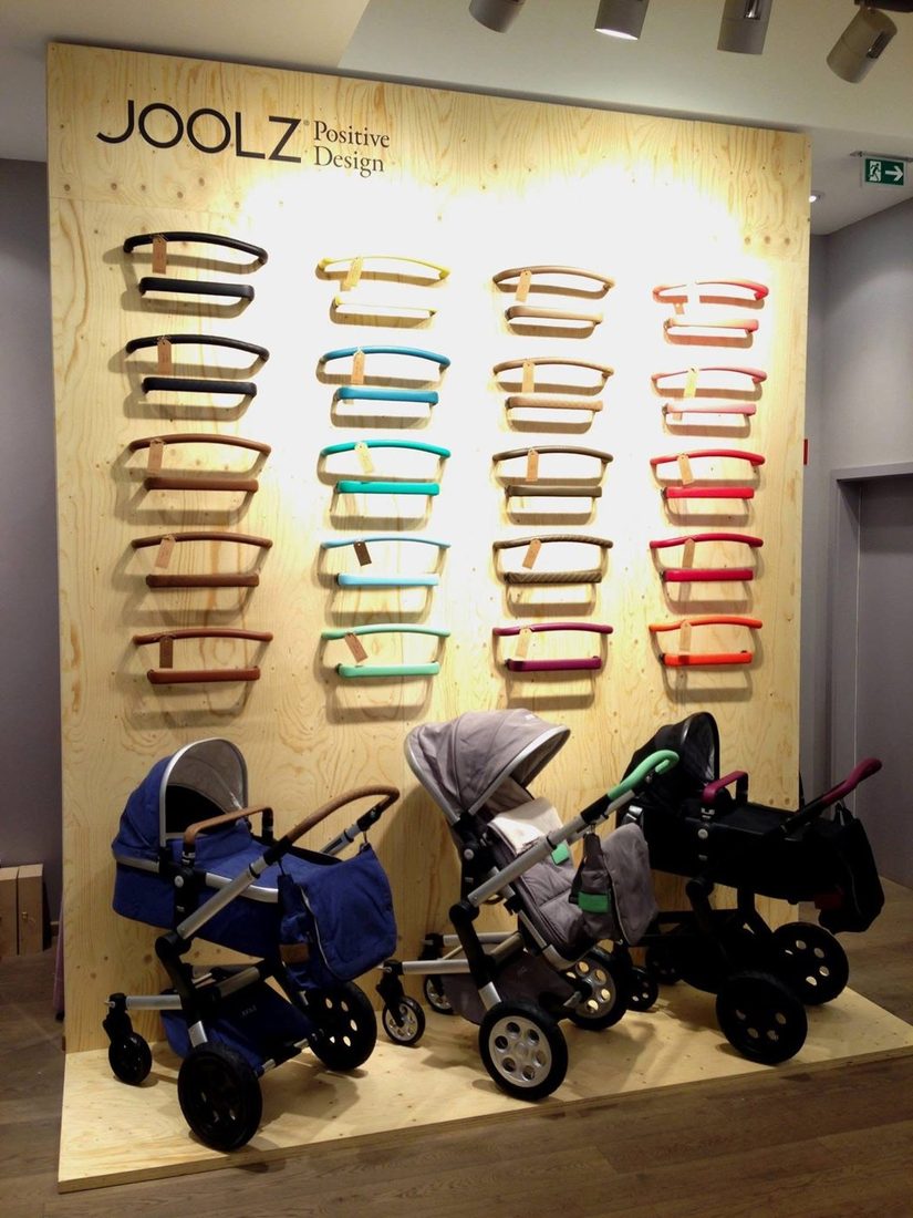 Joolz shop-in-shop with a wooden wall, coloured handlebars and strollers at Baby Kochs in Düsseldorf